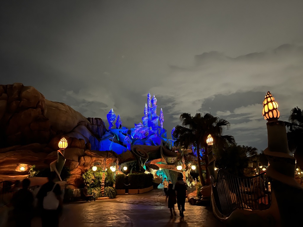 Photo of a castle in being lit up with vibrant blue lighting.