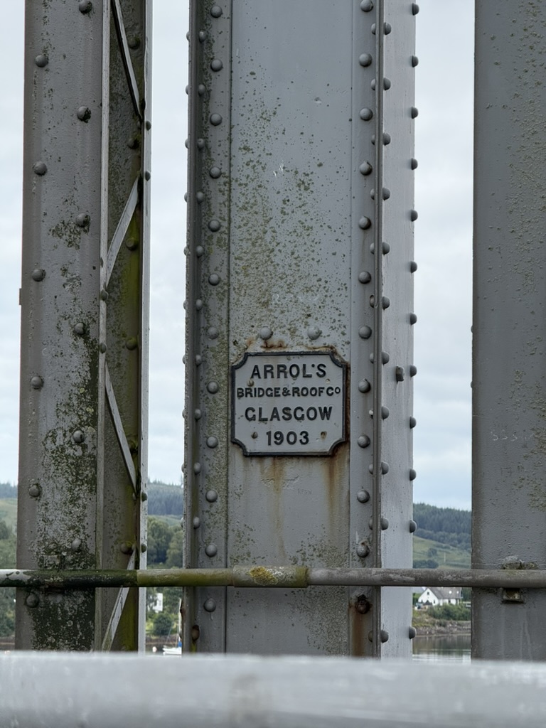 Close‑up of Connel Bridge steelwork with 1903 maker’s plaque.