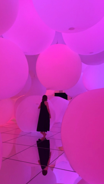 Giant orbs that are part of the exhibit with a pink glow.