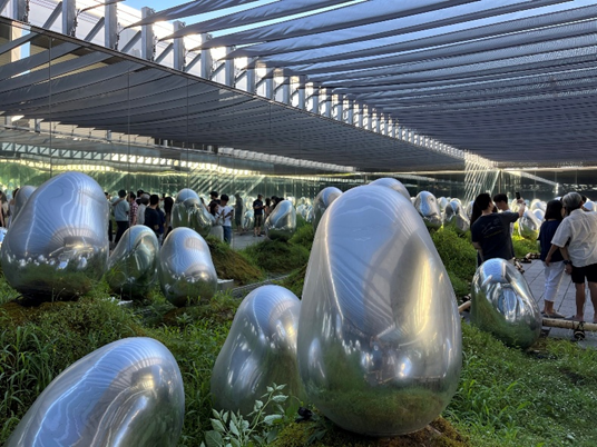 Metal orbs in moss garden that can light up