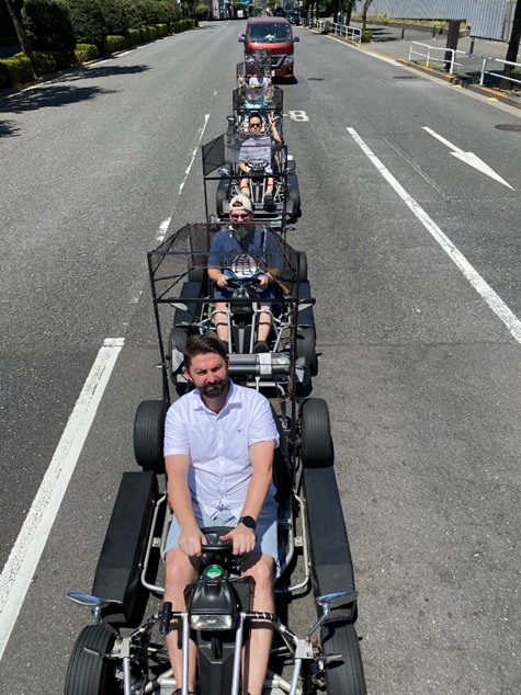 Line of a few people in Go Karts on the streets of Tokyo