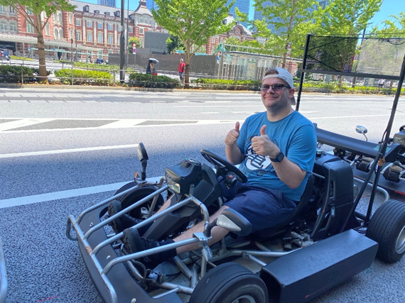 Matthew Jones on a Go Kart with his thumbs up